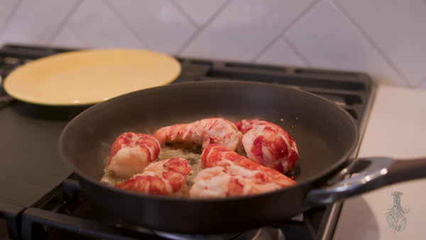 cooking lobster tail meat in pan with butter and garlic